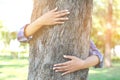 Women hug big tree