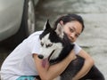 Women hug siberian husky