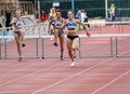 Women at the hurdles race Royalty Free Stock Photo
