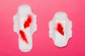 Women hygiene products or Sanitary pad with red feather on colored background. Pastel color. Closeup. Empty place for
