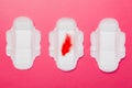 Women hygiene products or Sanitary pad with red feather on colored background. Pastel color. Closeup. Empty place for