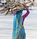 WOMEN INDIA LOADS WOOD IN FRONT OF MEN