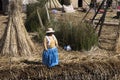 women with indigenous straw hat from the uros culture, standing on floating island of totora on lake titicacsa dressed in colorful Royalty Free Stock Photo