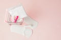 Women intimate hygiene products - sanitary pads and tampons on pink background, copy space. Menstrual period concept. Top view, Royalty Free Stock Photo