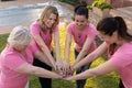 Women joining hands for breast cancer awareness Royalty Free Stock Photo