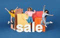Women jumping near large bags and word sale, blue background Royalty Free Stock Photo