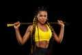 Women with jumping rope on black background. Beautiful young women standing with a jumping rope Royalty Free Stock Photo