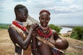 A women of the Karo ethnic group paints the face of a friend