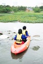 Women kayaking in the Taman Tasik Cempaka lake in the morning