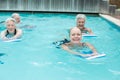 Women with kickboard swimming in pool Royalty Free Stock Photo