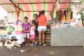 Women and kids in small shop on river bank