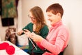 Women knitting with red wool. Eldery woman transfering her knowl Royalty Free Stock Photo