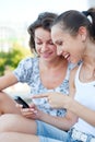 Women laughing and looking at cellphone Royalty Free Stock Photo