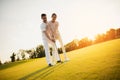 Romantic date on the golf course. Couple learning to play golf Royalty Free Stock Photo