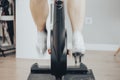 Women leg with white cycling boots cycling on a spinning gym bike indoor scene with motion fast blur Royalty Free Stock Photo