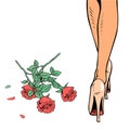 Women legs in heels and a bouquet of red roses on the floor