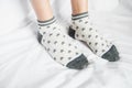 Women legs in socks colors alternating, side stand on white fabric floor. Royalty Free Stock Photo