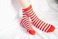 Women legs in socks colors alternating, side stand on white fabric floor. Royalty Free Stock Photo