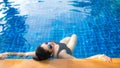 Women lifestyle relaxing near luxury swimming pool sunbath, summer day at the beach resort in the hotel. Royalty Free Stock Photo