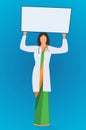 A woman holding up an advertising white banner. Professional lady doctor showing displaying white blank board or placard for ads Royalty Free Stock Photo