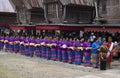 Women lined up carrying drinks to entertain guests who attended the traditional funeral rituals of the Toraja people