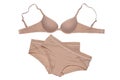 Women lingerie isolated. Close-up of beige or flesh-colored bra and two panties isolated on a white background. Useful for wearing