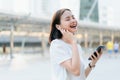 Women are listening to music from white headphones. And using hands touch to use various functions. Royalty Free Stock Photo