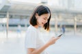 Women are listening to music from white headphones. And using hands touch to use various functions, happy mood. Royalty Free Stock Photo