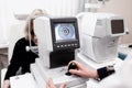 Women looking at eye test machine in ophthalmology clinic