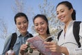 Women looking at the map, holding binoculars Royalty Free Stock Photo
