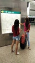 Women looking at screens in airport