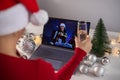 Women make a video call on a laptop. Girls drink champagne, celebrate Christmas and communicate remotely on the computer