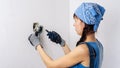 Women in the male profession: A girl repairs an electrical switch with a screwdriver and pliers. Royalty Free Stock Photo