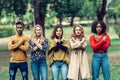 4 women and a man with arms crossed and fists clenched as a symbol of resistance to machismo Royalty Free Stock Photo