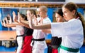 Women and man exercising kata movements