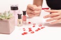 Women manicure and attaches a nail shape during the procedure of nail extensions with gel at home. Fashion and Beauty concept