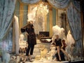 Women mannequins among vintage items in a store window in winter