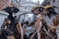 Women in masks and costumes with Bridge of Sighs behind, at Venice Carnival Royalty Free Stock Photo