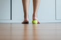 Woman massage with tennis ball to her foot in bedroom,Feet soles massage for plantar fasciitis