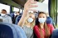 Women in medical masks taking selfie in travel bus Royalty Free Stock Photo