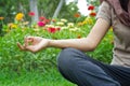 Women meditating outdoors in flower park background