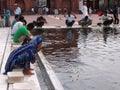 Women and men perform their ablutions in the designated area next to the main entrance of the Jama Masjid Mosque in New Delhi, Ind Royalty Free Stock Photo