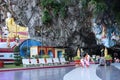 Women monks entering a pagoda built inside a cave. Female monks passing by a big reclining Buddha statue inside the temple. Hpa An