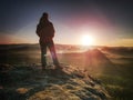 Hiker girl stay in strong Sun rays with many flares around her body Royalty Free Stock Photo