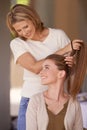 Women, mother and daughter in home, hairdresser or happy for helping hand, conversation and family home. People, girl Royalty Free Stock Photo