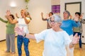 Women moving coordinated closing a qi gong class Royalty Free Stock Photo