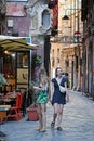 Women on Narrow Historic Street, Via dei Giustiniani, Genoa, Italy.