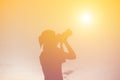 Women Nature photographer with digital camera on the mountain