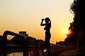 Women and nunchaku in hands silhouette in sunset, martial arts