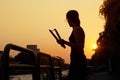 Women and nunchaku in hands silhouette in sunset, martial arts